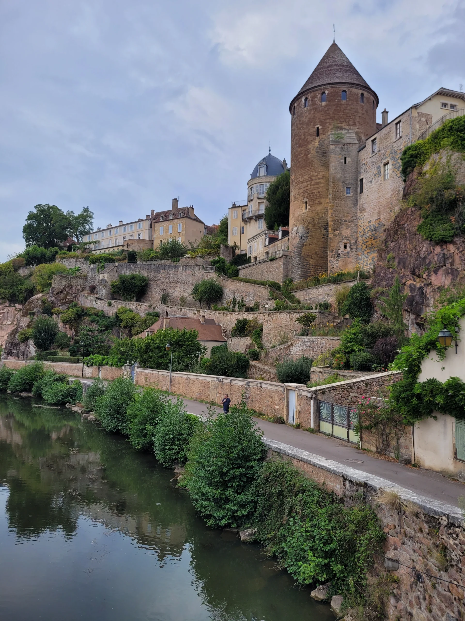 Medieval castle tower above a river in the French countryside