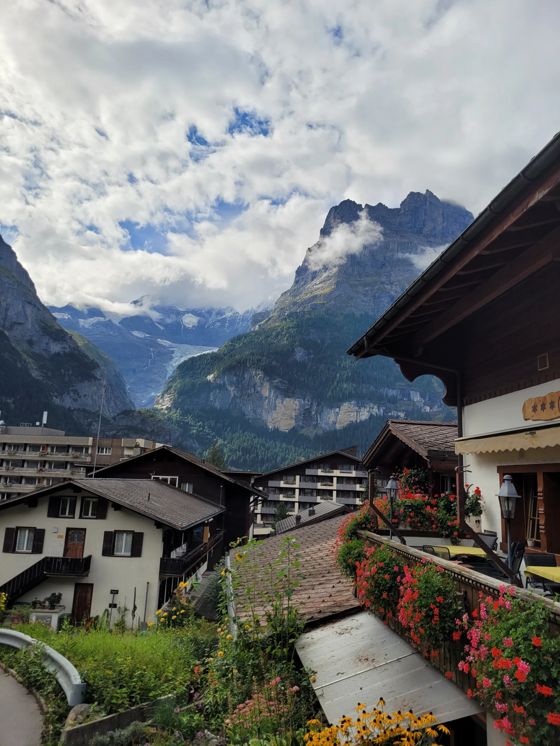 Grindelwald village with flower balconies and glacier mountain peaks