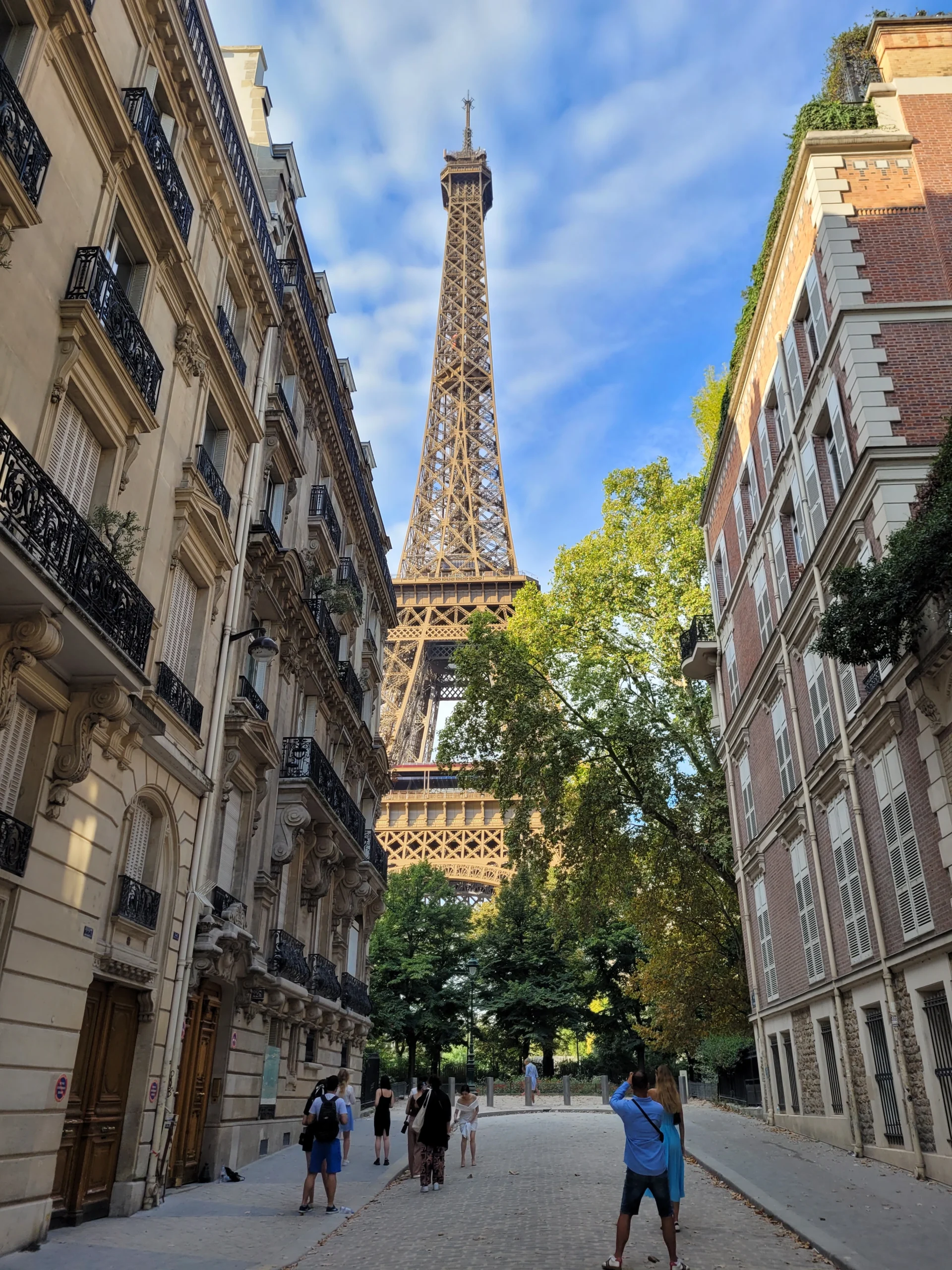 Eiffel Tower viewed from a cobblestone street in Paris